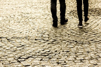 Person Waling on Concrete Bricks Road