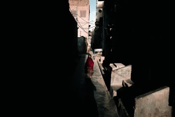 Person Walking Along Dark Alley