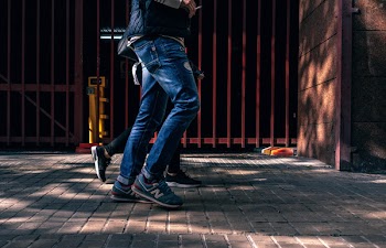 Person Walking Beside Another Person Outside