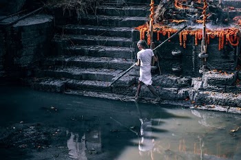 person walking beside body of water