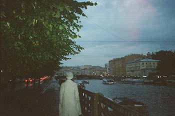 Person Walking Beside Body of Water