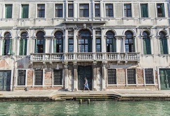 Person Walking Beside Building