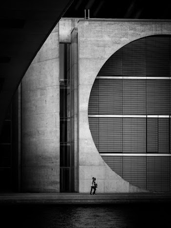 Person Walking Beside Building