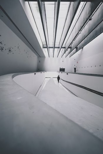 person walking beside wall