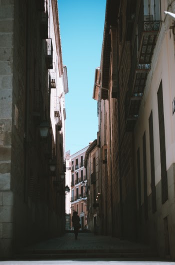 Person Walking Between of Houses