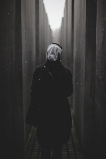 Person Walking Between Walls