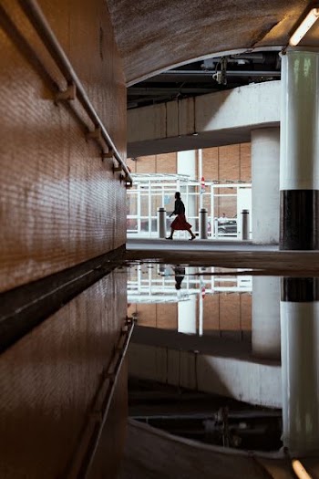 person walking inside concrete building