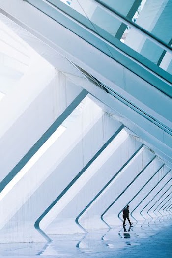 person walking inside glass building