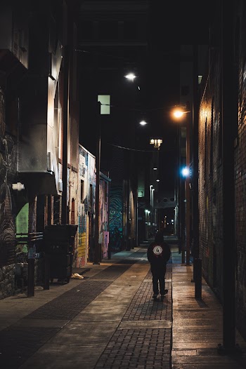Person Walking On Alley At Nighttime