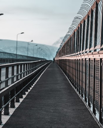 Person Walking on Bridge