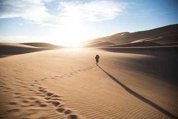 person walking on desert