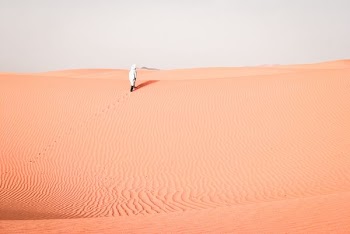 person walking on desert during daytime