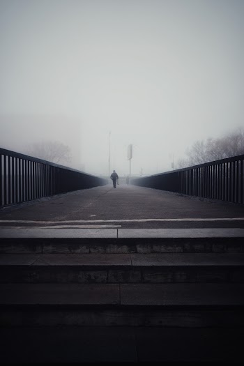 Person Walking on Footbridge