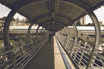 Person Walking On Footbridge