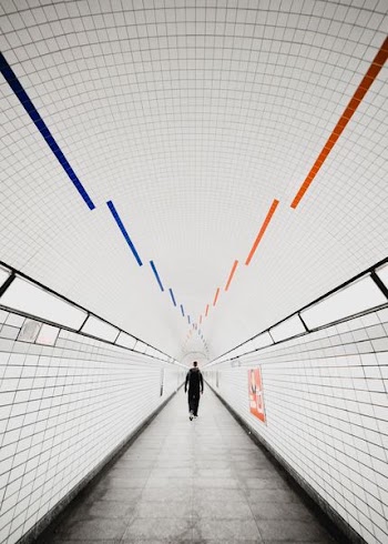 person walking on grey and white pathway