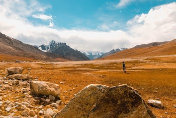 Person Walking On Open Field