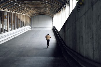 Person Walking on Paved Road