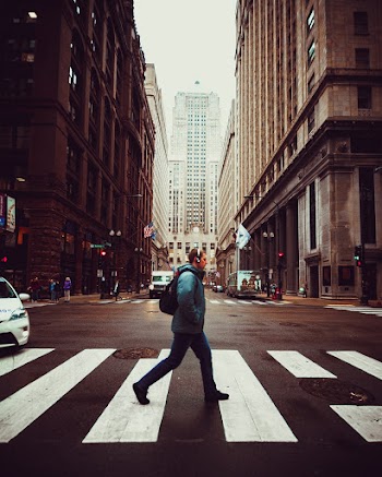 Person Walking On Pedestrian Lane