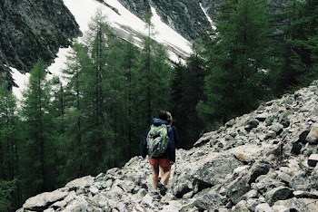 Person Walking on Rocky Road