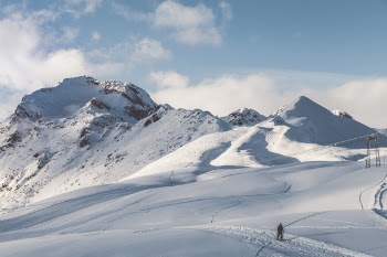 Person Walking On Snow Mountain