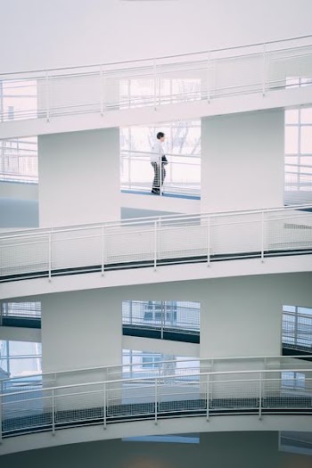 person walking on stairs inside building during daytime