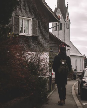 person walking towards the house