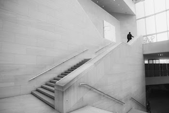 Person Walking Up Stairs Grayscale Photo