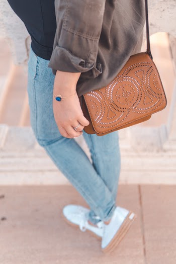 Person Walking While Carrying Sling Bag