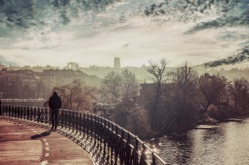 Person Walks Near Black Handrail