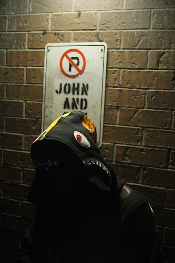 Person Wearing a Black and Orange Bathing Ape Hoodie