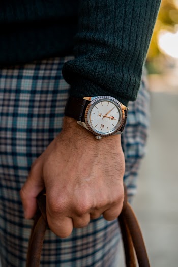 Person Wearing Black and Gold Analog Watch