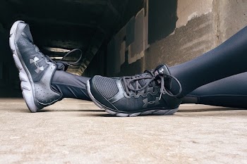 Person Wearing Black-and-gray Under Armour Running Shoes