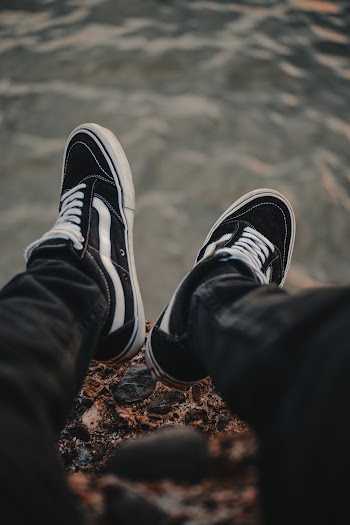 Person Wearing Black-and-white Vans Low-top Sneakers