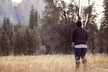 person wearing black beanie and raglan shirt while being photograph during day time