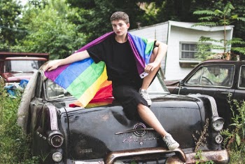 Person Wearing Black Crew-neck T-shirt Sitting on Vehicle