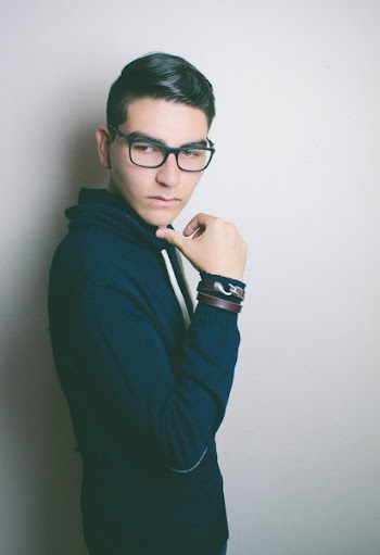Person Wearing Black Eyeglasses and Blue Hoodie Jacket