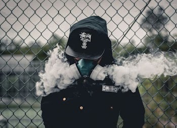 person wearing black fitted cap