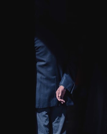 person wearing black formal suit