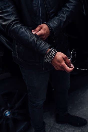 Person Wearing Black Jacket And Bracelets
