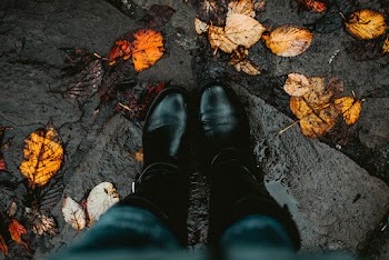 Person Wearing Black Leather Boots