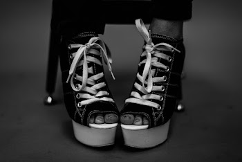 Person Wearing Black Leather Peep-toe Wedge Booties