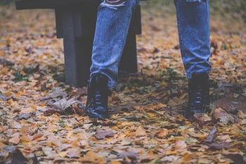 Person Wearing Black Leather Shoes Standing Near Furniture