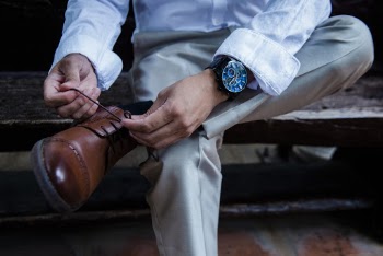 Person Wearing Black Leather Strap Round Analog Watch