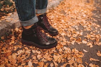 person wearing black leather work boots