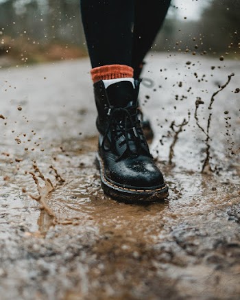 Person Wearing Black Leather Work Boots