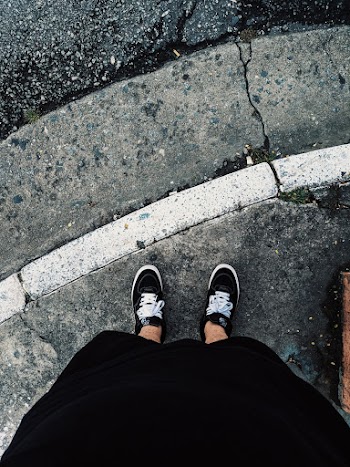 Person Wearing Black Low Top Sneakers
