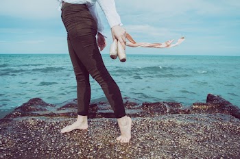 Person Wearing Black Pants Standing Beside of Seashore