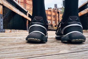 Person Wearing Black Running Shoes
