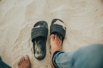 Person Wearing Black Slippers