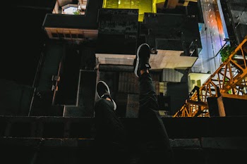 Person Wearing Black Sneakers